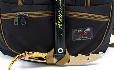 detail visible^^A close shot of an ice axe threaded through the ice axe loop on the face of the Guide's Edtiion Synapse 25.