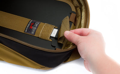 detail visible^^A person closing the pull tab of the removeable frame sheet over the t-bar and aluminum center stay to lock it in place inside the Guide's Edition Synapse 25.