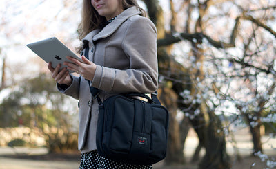 lifestyle visible^^Person outdoors holding an iPad while wearing the Co-Pilot.