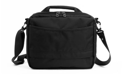 lifestyle visible^^Photo showing the back of the Co-Pilot with its open-top pocket and bottom zipper so it can fit over the handle of rolling luggage.