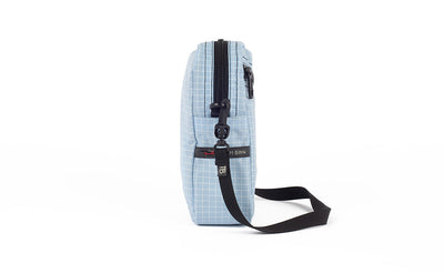 visible variant TB0416-ADLE TB0416-ADNE^^A side view of the Everyday Cubelet in Acuity Halcyon (light blue with a white grid) showing the o-ring attachment point and included 5/8" strap.