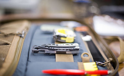 A close shot of the webbing loops with tools attached on the interior of the Founder's Briefcase.