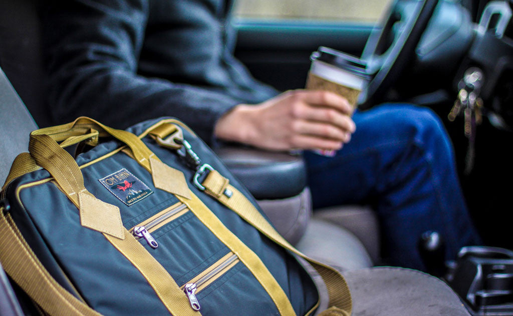 lifestyle visible^^A Founder's Briefcase in the passenger's seat of a car.