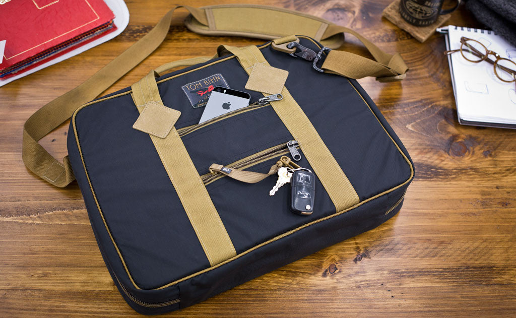 Founder's Briefcase with a cellphone and keys in the rear zippered pockets.