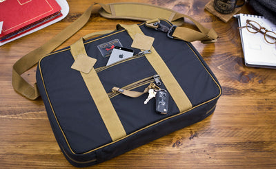 Founder's Briefcase with a cellphone and keys in the rear zippered pockets.