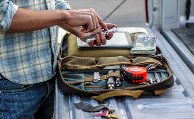 lifestyle visible^^A person packing up an open Founder's Briefcase.