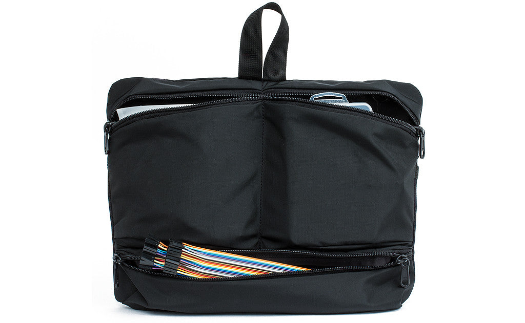 visible variant TB1836-BJ^^ The Black Maker's Bag / Swift Freudian Slip holding knitting needles and other knitting tools.