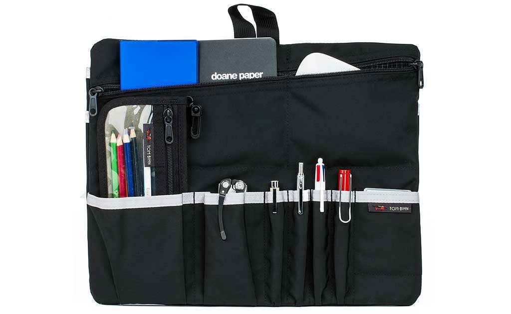 visible variant TB1845-BJ ^^ The Black Tri-Star / Western Flyer Freudian Slip, holding pens, a multi-tool, a pencil pouch, two small notebooks and a wireless mouse.