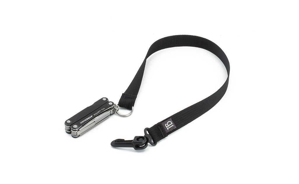 visible variant TB0516S-BA^^A 16-inch Black Key Strap with a snaphook at one end and a split-ring o-ring at the other with a pocket knife fed through the split-ring o-ring.
