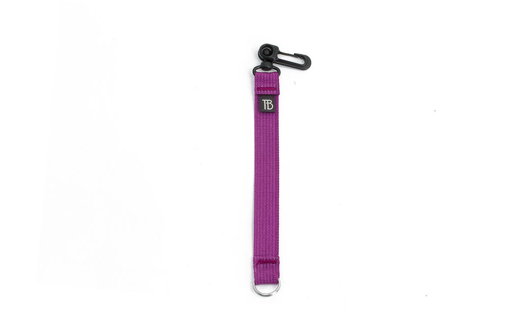 visible variant TB0515S-UA^^An 8-inch Ultraviolet (purple) Key Strap with a snaphook at one end and a split-ring o-ring at the other.