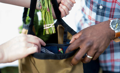 lifestyle visible^^A person removing flowers from a Moveable Feast.