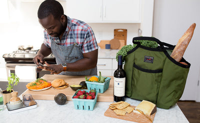 lifestyle visible^^A cook preparing some food with a Moveable Feast partially filled on his counter.