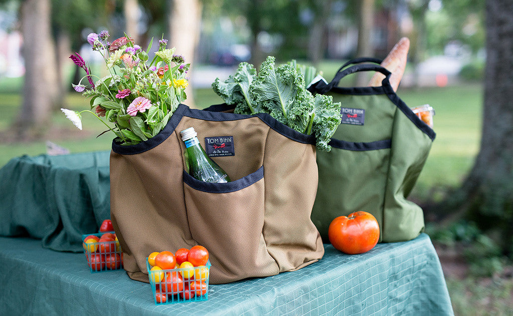 lifestyle visible^^A pair of filled Moveable Feasts on a picnic table. 