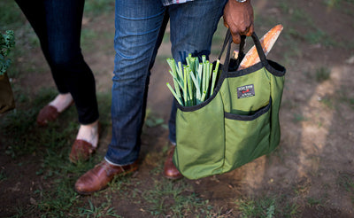 lifestyle visible^^A person carrying leeks and a baguette in a Moveable Feast.