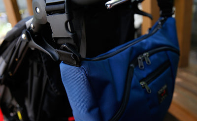 lifestyle visible^^Parental Unit hung to a stroller using the Stroller/Wheelchair Strap.