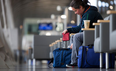 lifestyle visible^^A person inserting a Passport Pouch into their Pilot bag.