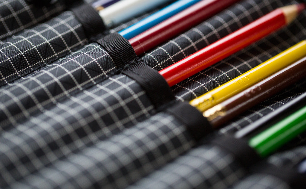 A close shot of the Tool Pen Wrap filled with colored pencils.