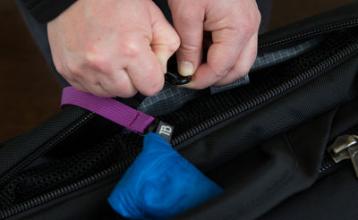  lifestyle visible^^A Pocket Travel Pillow attached to a bag via a Key Strap.