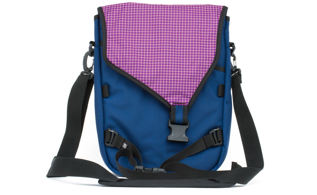 visible variant TB0243-NBUD^^The Ristretto in Navy (dark blue) 1050 Ballistic with Ultraviolet (purple with white grid) 200 Halcyon interior.