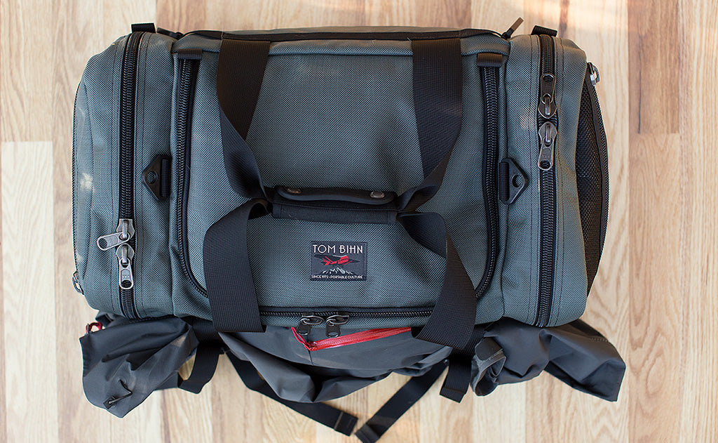 lifestyle visible^^The Road Buddy Lash Straps holding a jacket on a Road Buddy Duffel