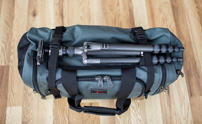lifestyle visible^^The Road Buddy Lash Straps holding a camera tri-pod.