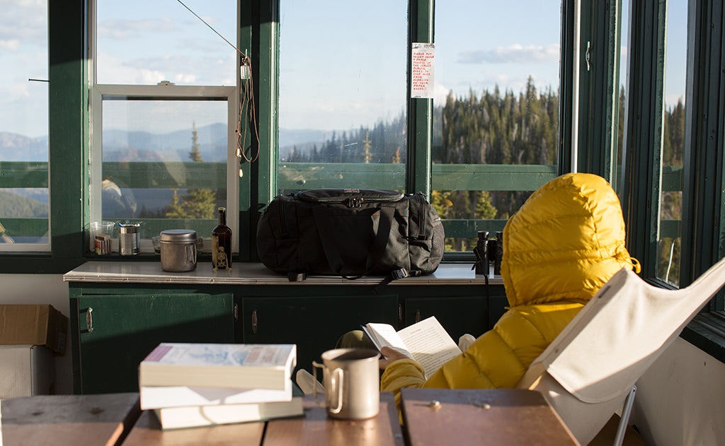 lifestyle visible^^A Road Buddy Duffel in a fire lookout tower.