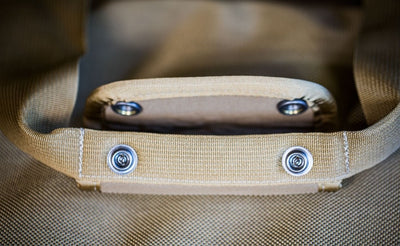 detail visible^^A close shot of the padded carry handle unsnapped on a Skookum Dog Road Duffel