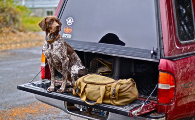 lifestyle visible^^The Medium Road Duffel on a truck bed.