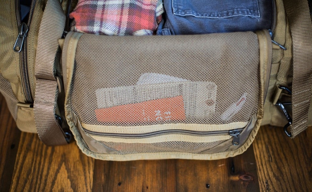 lifestyle visible^^Close shot of the mesh underflap pocket on a Medium Road Duffel.