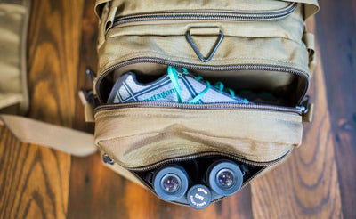 lifestyle visible^^A close shot of the end pocket and side pocket open on a Medium Road Duffel.