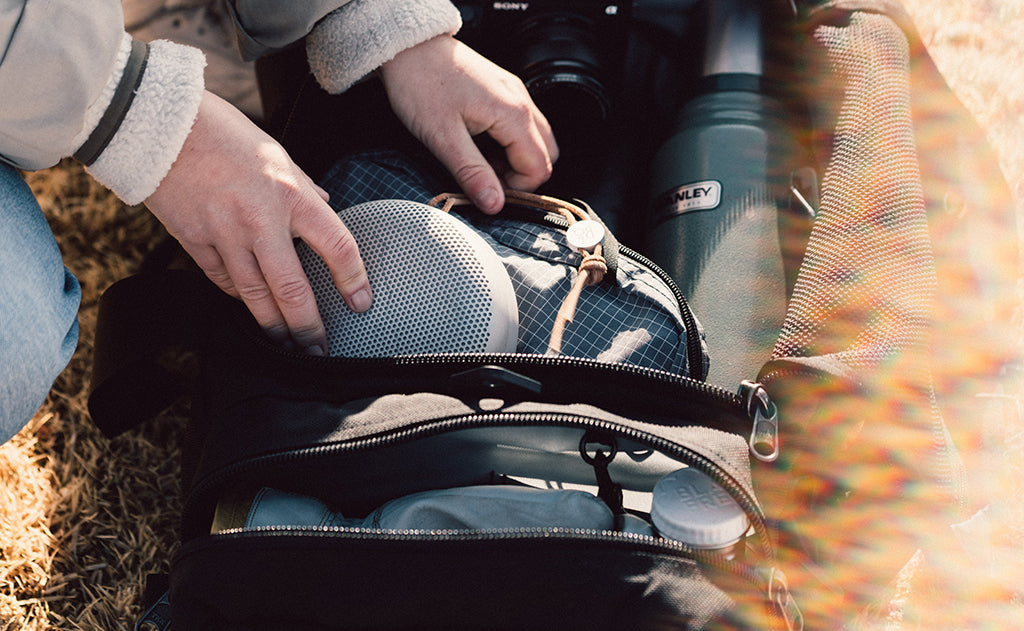 lifestyle visible^^A person accessing the Road Buddy Duffel 60's main compartment.