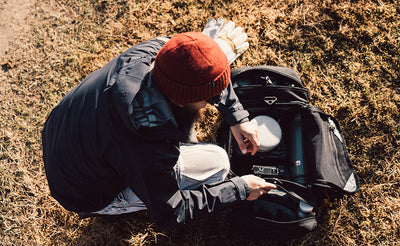 lifestyle visible^^A person accessing the Road Buddy Duffel's main compartment.
