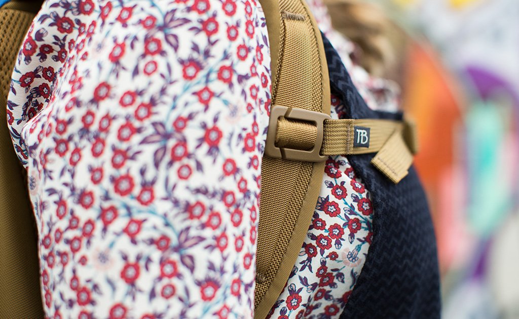 lifestyle visible^^A close shot of a person wearing a Guide's Edition Synik 22 with the sternum strap buckled.