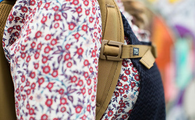 lifestyle visible^^A close shot of a person wearing a Guide's Edition Synik 22 with the sternum strap buckled.