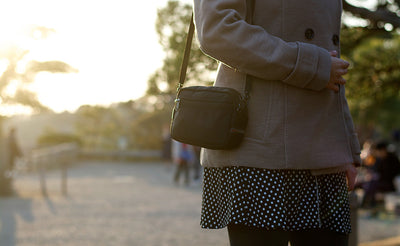 A person carrying the the Side Effect as a should bag using the included 5/8 Shoulder Strap.