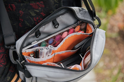 visible lifestyle^^A person carrying the Side Hustle with watercolor supplies inside.