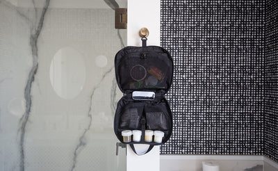 lifestyle visible ^^The Deluxe Spiff Kit hung hanging on a hanger point in a hotel restroom via the hanging hook.