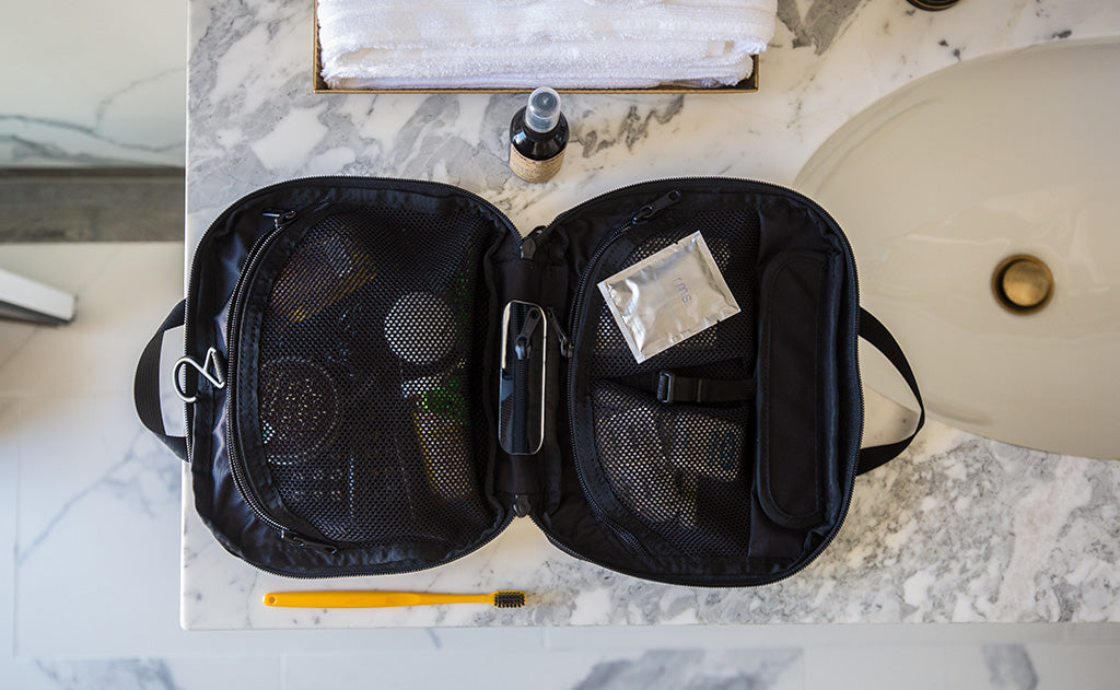 lifestyle visible^^The Deluxe Spiff Kit zipped open on a hotel restroom counter.