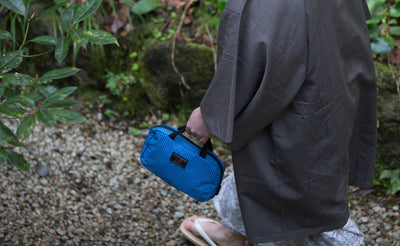 visible lifestyle^^A person carrying the Standard Spiff Kit by the nylon handles.