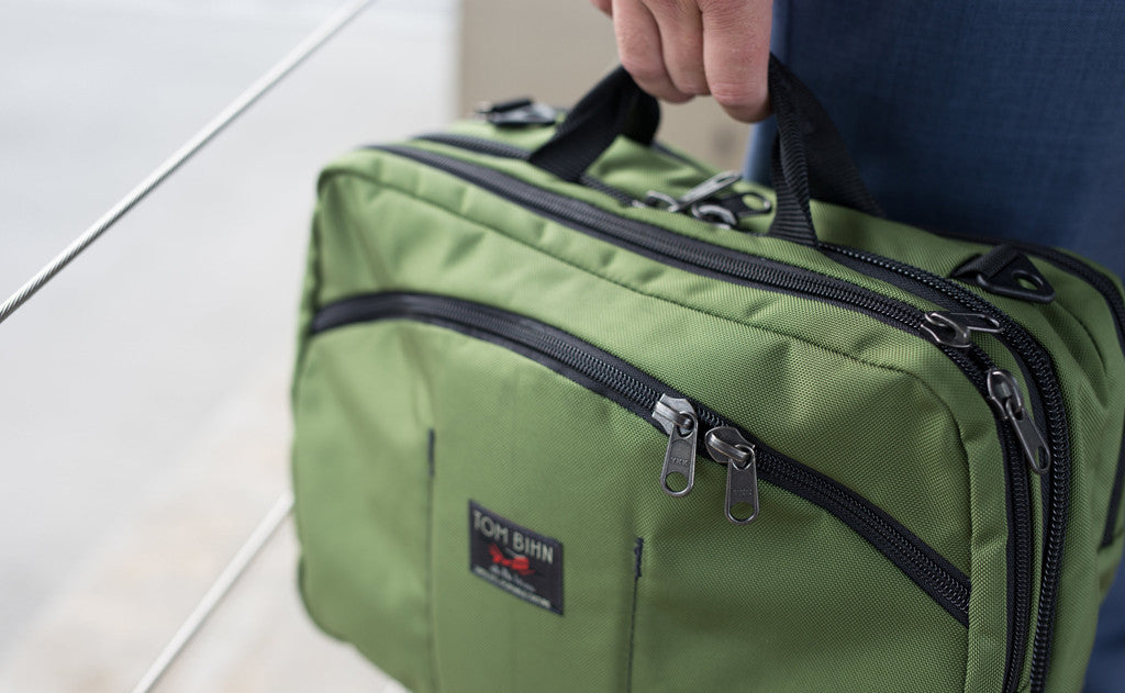 lifestyle visible^^A person carrying The Stowaway via the padded handles.