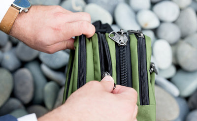 lifestyle visible^^A person accessing the front main pocket of The Stowaway.