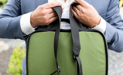 lifestyle visible^^A person holding The Stowaway via the backpack straps.