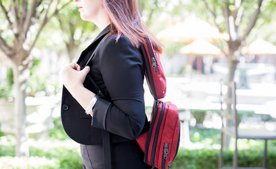 lifestyle visible^^A close shot of a person wearing the Stowaway using the backpack straps.