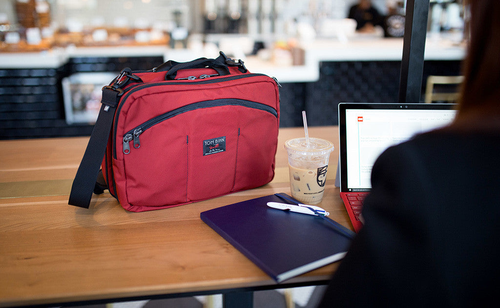 lifestyle visible^^A person at a coffee shop using their tablet with The Stowaway on the tabletop beside them.