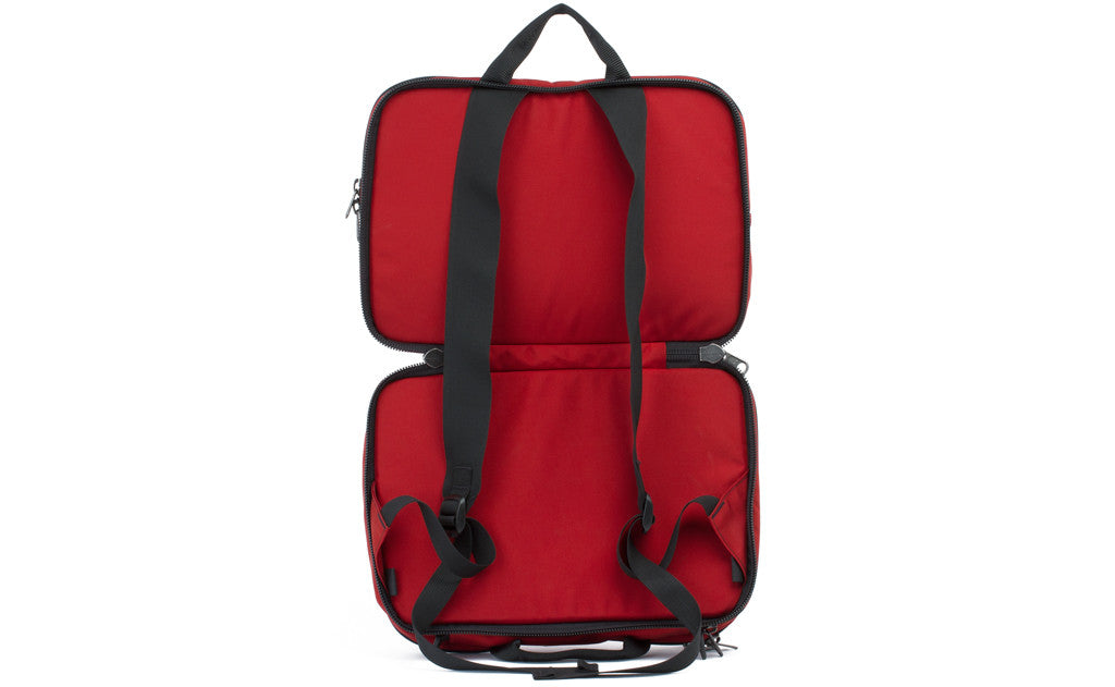 visible variant TB0975-MKLJ^^The Stowaway in Mars Red 525 Ballistic with the center compartment opened to reveal the backpack straps.