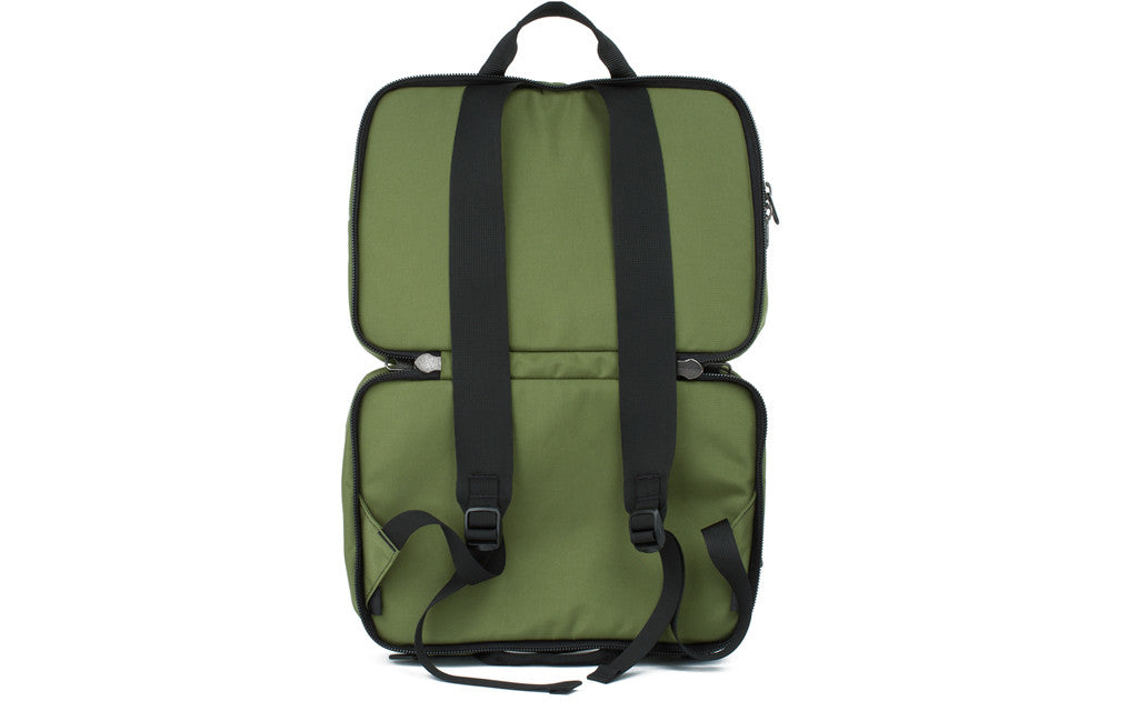 visible variant TB0975-OKYJ^^The Stowaway in Olive (green) 525 Ballistic with the center compartment open to access the backpack straps.