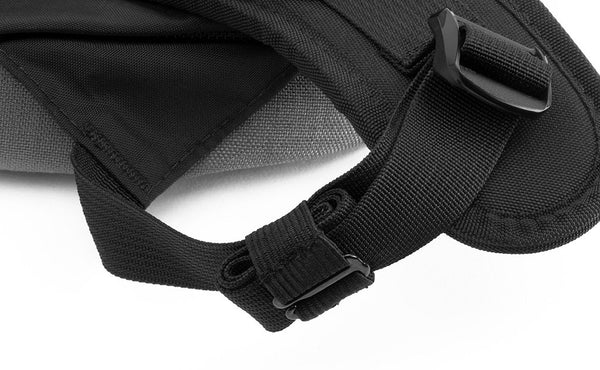 A Black Strap Keeper holding a shoulder strap's rolled excess length out in place.