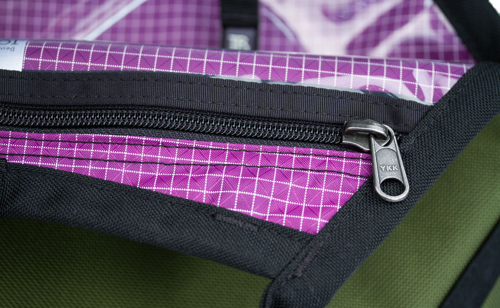 A close shot of the zippers on the clear urethane zippered pockets.