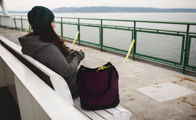 lifestyle visible^^A person at a bench on a ferry knitting out of the Swift.