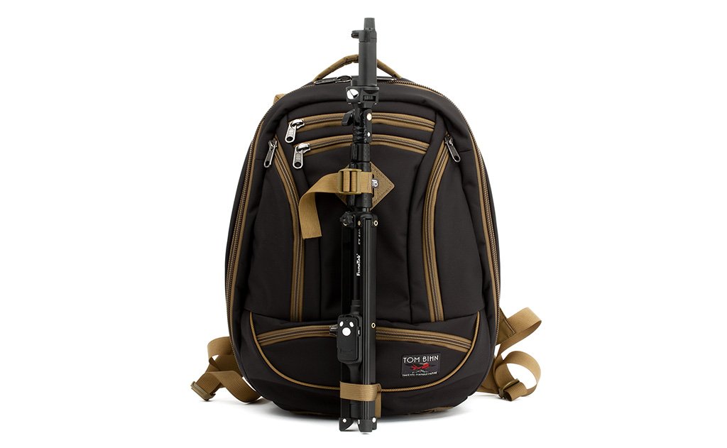 detail visible^^A Guide's Edition Synik 22 with a tripod lashed to the face of the bag using the front lashpoint and ice axe loop.